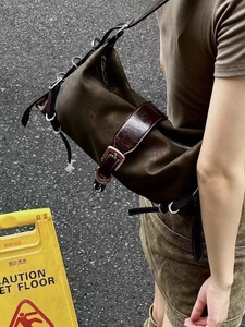 Dettaglio borsa a tracolla marrone vintage con anelli metallici a D e stile punk