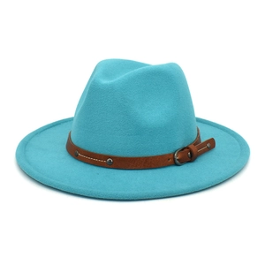 Detail of turquoise fedora hat with brown leatherette band and silver studs on white background