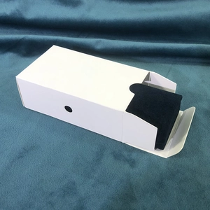 Detail view of the white travel jewelry box showing dark blue fabric lining and packaging