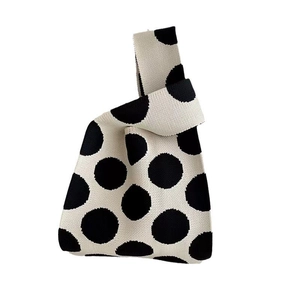 Minimalist cream knit tote bag with black polka dot pattern and single handle design