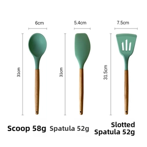 Close-up of Morandi green silicone spoon, spatula, and slotted turner with wooden handles