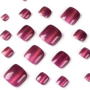 Cat eye press-on toenails in deep reddish-purple shades on a clean white background