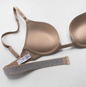 Macro detail of nude plunge bra showing rhinestone band and size 70B laundry label