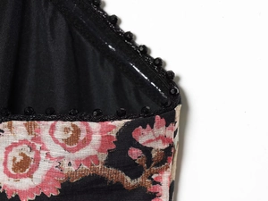 Macro detail of linen blend dress with floral print and black faceted bead trim