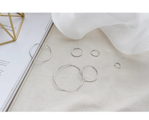 Macro shot of various sizes of polished S925 sterling silver hoop earrings set