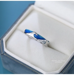 Macro detail of S925 sterling silver ring with blue gradient wave enamel and smooth finish