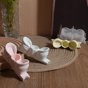 Detailed view of 3D bow-knot silicone molds for DIY scented candle holders and resin crafts