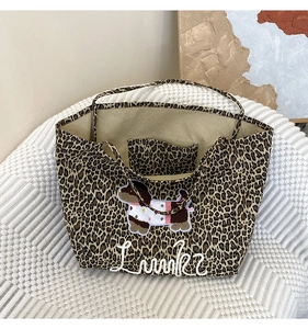 Detail of leopard print tote bag with cute dog embroidery and Lucky lettering