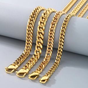 Gold-plated stainless steel Cuban link necklaces in various widths on grey display stand