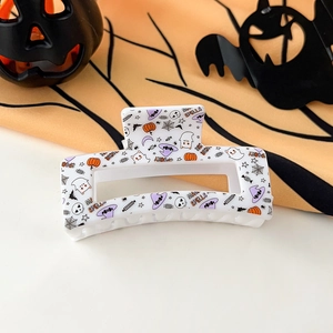 Detail view of Spooky Halloween hair claw clip with ghost and pumpkin graphic patterns