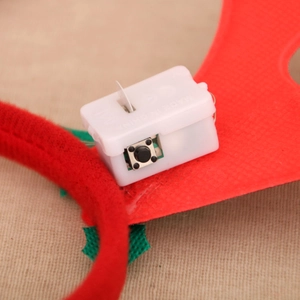 Detailed macro view of the white battery box and black switch on a festive headband