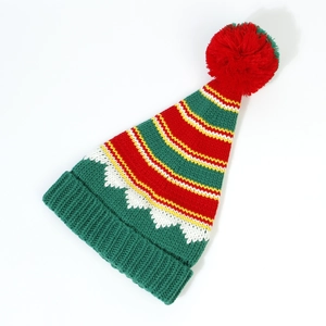 Detail of red and green striped Christmas knit hat with a large red pompom ornament