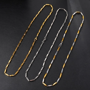 Three minimalist stainless steel necklaces in gold, silver and two-tone finishes