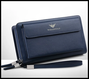 Detail of blue cross-grain leather men's clutch featuring gold logo and dual metal zippers