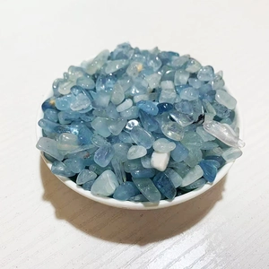 Top view of natural irregular blue crystal gravel in a small white round dish