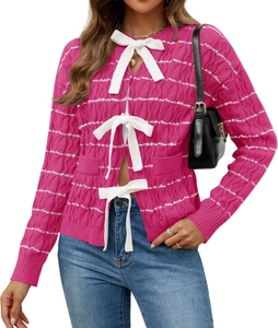 Detailed knit texture of pink women's cardigan with white ribbon bow closures