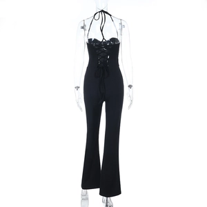 Detail of sexy backless black jumpsuit featuring cross-back straps and flared legs
