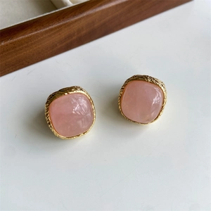 Pink crystal square stud earrings with gold braided metal edges in a pair