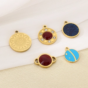 Detailed close-up of various gold stainless steel charms with celestial and gemstone patterns