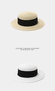 Vertical view of flat top straw boater hats in beige and white with polka dot ribbons