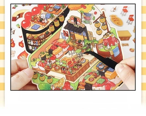 Detail showing hands assembling a 3D DIY miniature sushi shop sticker with tweezers
