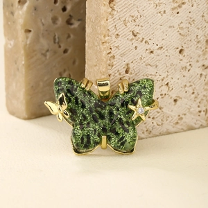 Green butterfly pendant with gold star and mini butterfly detail on natural stone