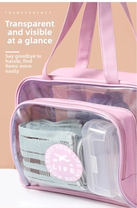 Close-up of pink waterproof travel bag showing transparent PVC window and mesh storage