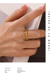 Detailed view of an 18K gold plated geometric cage ring worn by a fashion model