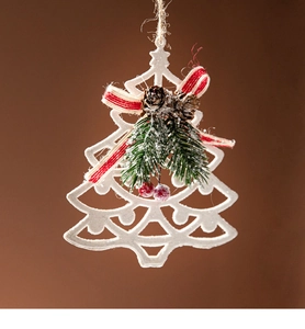 Close-up of white glitter Christmas tree ornament with pine cones and red ribbon