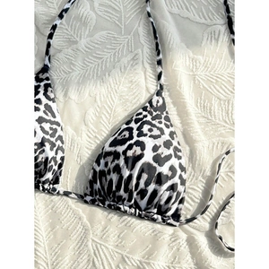 Detailed view of leopard print bikini top fabric and textures on a soft background