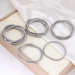 Silver multi-layer coiled snake chain bracelet with textured metal threading and clasps