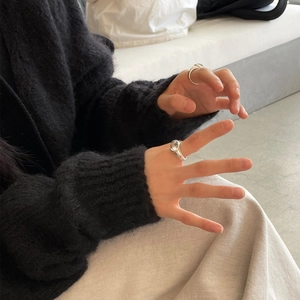 Close-up of minimalist S925 sterling silver rings with zircon on a model's hand