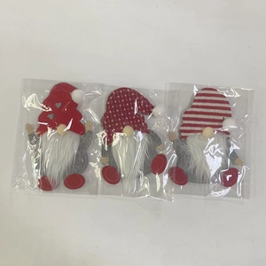 Three Christmas gnome cutlery holders in red and grey felt with long white beards