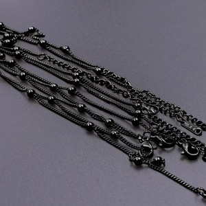 Detail of 1.5mm black stainless steel ball chains with lobster clasps and S.STEEL tags