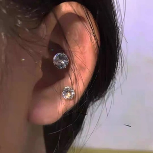 Close-up of magnetic zircon ear clips for non-pierced ears showing secure fit on the ear