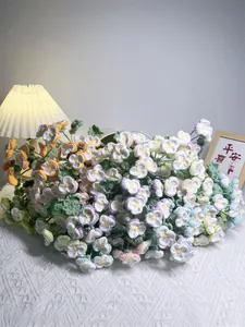 Handmade crochet pansy bouquet in vibrant colors with warm home ambient lighting