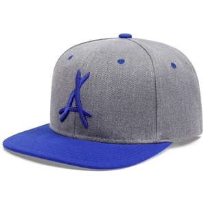 Macro view of textured grey fabric and blue 3D embroidered letter A on snapback cap