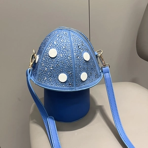 Detail of blue mushroom handbag with sparkling rhinestones and white polka dots on a seat
