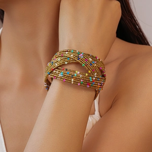 Detail of bohemian multi-layer beaded wrap bracelet with colorful beads and gold accents
