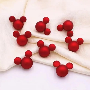 Macro shot of red matte Mickey-shaped ABS pearls for DIY jewelry making and crafts