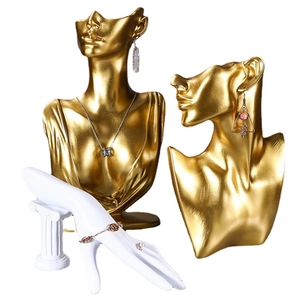 Golden bust and hand models for elegant necklace, earring, and ring jewelry displays