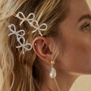 Detail of Korean style bow hair clips with rhinestones and pearls in gold and silver