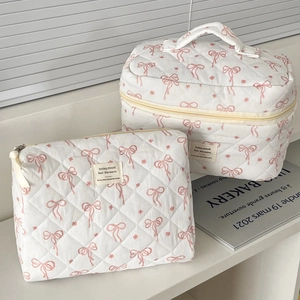 Floral quilted cosmetic bag set with pink bows and handle for travel and makeup storage