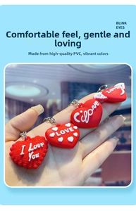 Detail of red PVC heart keychains featuring 3D embossed LOVE text and wing designs