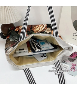 Top view of spacious canvas tote bag interior showing large storage for gadgets