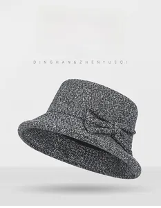 Detail of dark grey wool felt cloche hat featuring an elegant matching bow decoration
