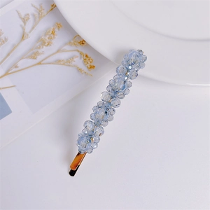 Elegant light blue crystal flower hair clip with golden base for women's hairstyles