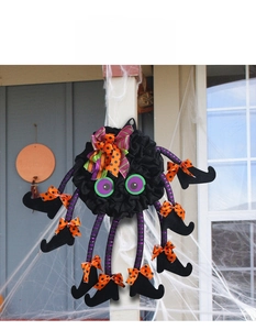 Detail of Halloween spider wreath with purple eyes and colorful polka dot bows for door decor