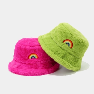 Plush faux fur winter bucket hats in rose pink and neon green with rainbow embroidery
