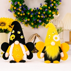 Detail of bee themed gnomes with wings and sunflowers in a warm garden setting
